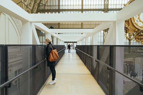 human woman standing near building corridor