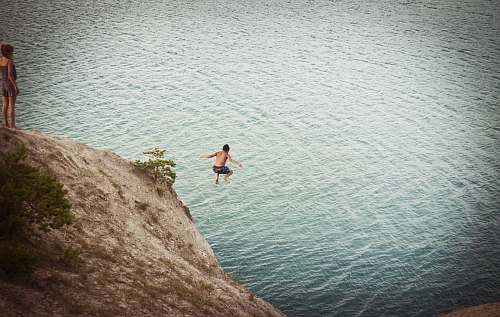jump man jumping on body of water jumping