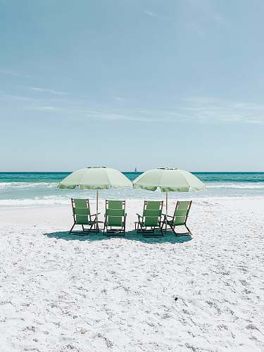 beach green chairs under umbrellas on shore chair