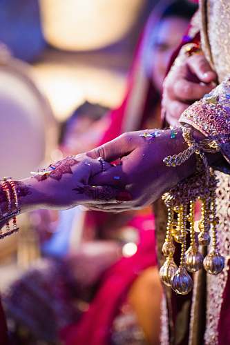 accessory person wearing gold and silver ring bead