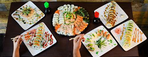 meal assorted sushi on plates on table lunch