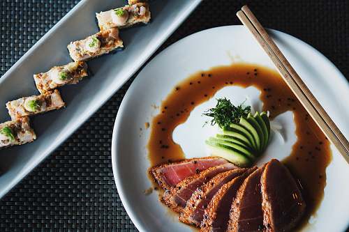 sushi meat with sauce and vegetable plate