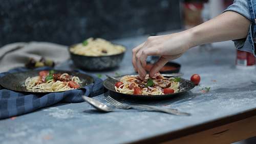 dinner person holding spaghetti sharjah