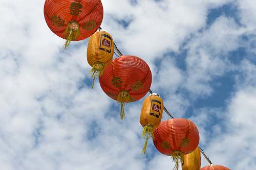 lamp red and orange lantern lamp under white clouds and blue sky during daytime chinatown