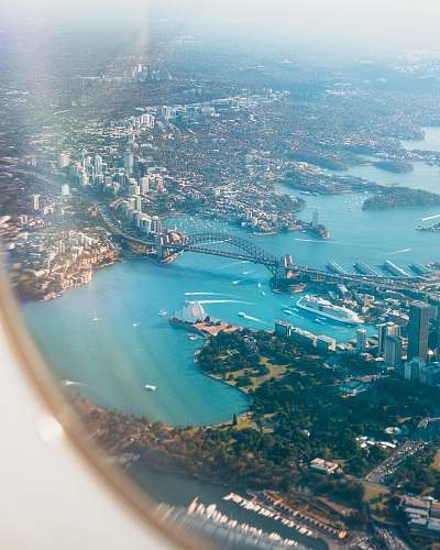 landscape aerial photography of city beside body of water aerial view