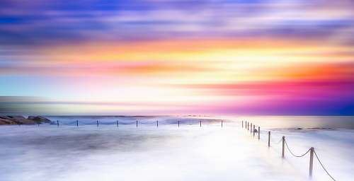 water sea of clouds beside metal rail ocean