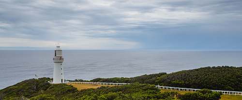 water white lighthouse on the edge of cliff coast