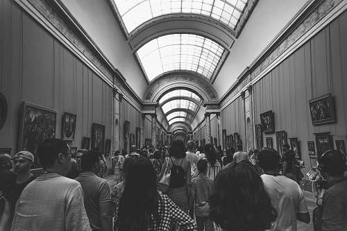 people group of people inside museum in grayscale photography human