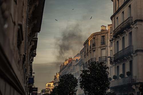 city white concrete building with black smoke outdoor urban