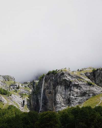 france mountains covered with green trees under cloudy sky during daytime outdoors