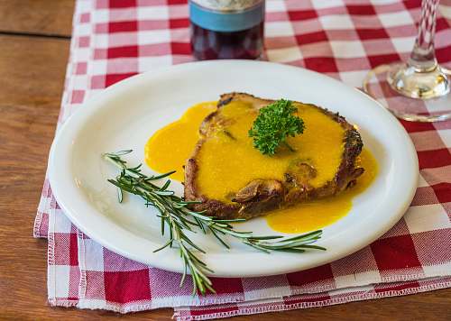 plate Cooked pork chop on round white ceramic plate cup