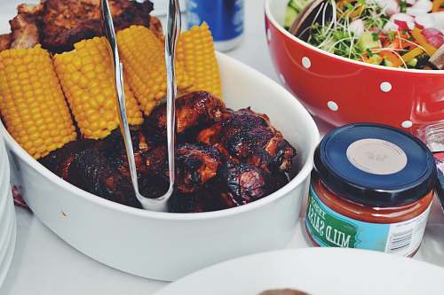 bbq grilled food and corn cob on oval pan salad