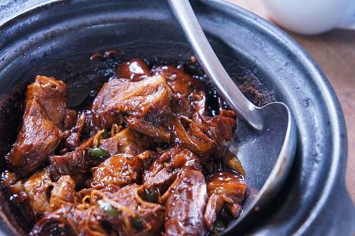 bbq meat with sauce in black bowl meat
