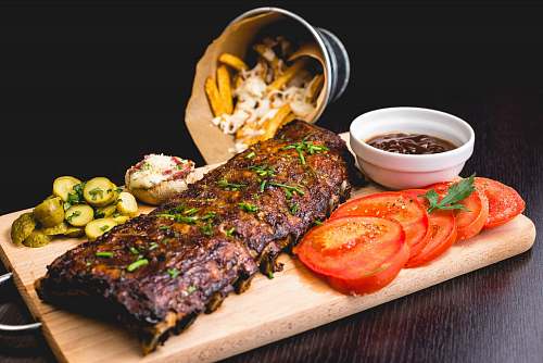 steak roasted ribs with sliced tomatoes and potatoes dinner