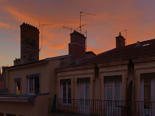 lyon building with antennas and chimneys during golden hour antenna