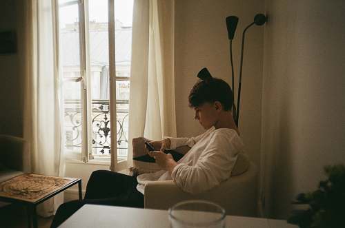 person boy sitting on sofa chair room