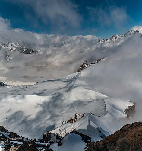 mountain bird's eye photography of mountain surrounding snow snow