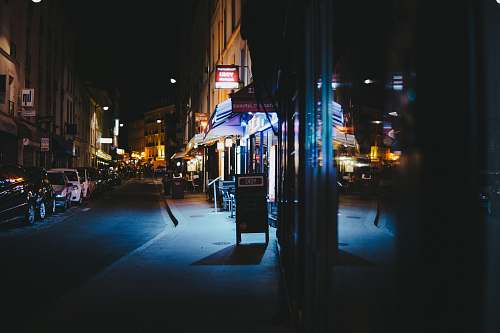 france cars parked in front of stores during nighttime street