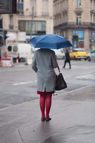 human woman standing and holding umbrella umbrella