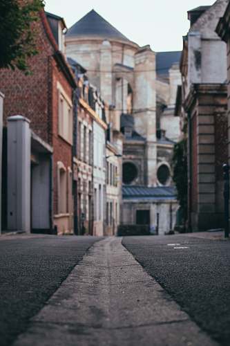 building gray road between buildings during daytime street