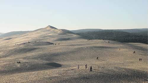 nature people gathered on desert under gray sky sand