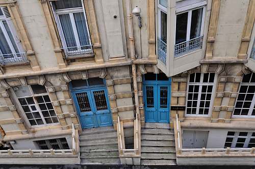 building top view of beige, blue, and brown concrete building at daytime curtain