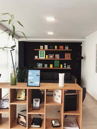 table black iPad near lucky bamboo in vase on brown wooden shelf inside room furniture
