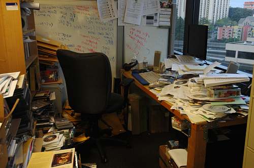 furniture office table with pile of papers chair