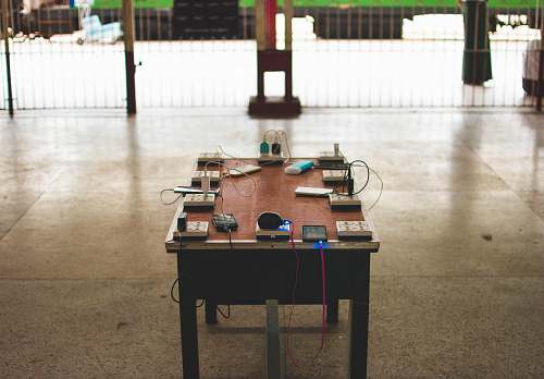 table power sockets and travel adapters on brown wooden table furniture