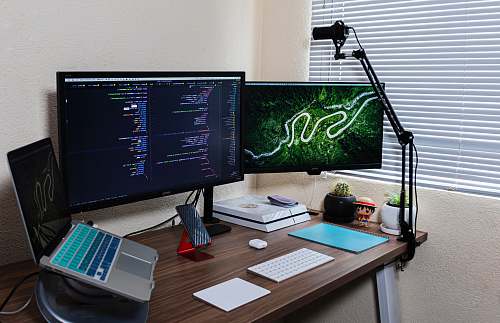 table black flat screen computer monitor on brown wooden desk desk