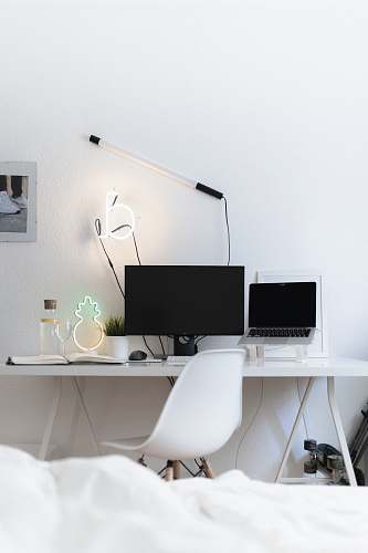 table black flat screen computer monitor on white table desk