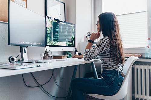 desk girl using desktop computer in room table