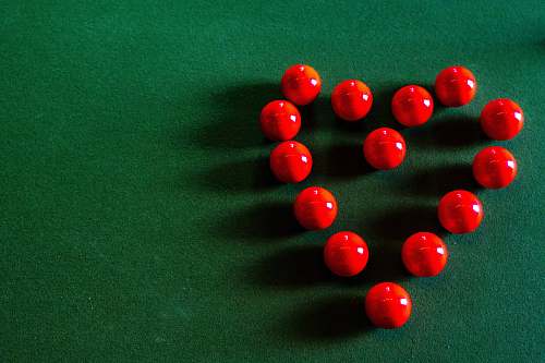 table red round beads on green textile indoors