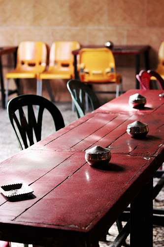 table three stainless steel pots on red table chair