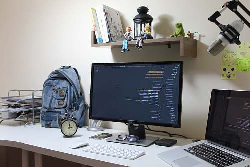 table turned-on flat screen computer monitor desk