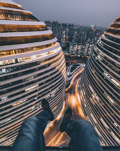 city person seating on building urban
