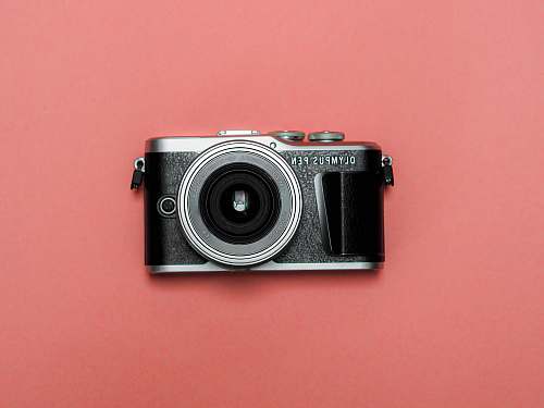 electronics black and silver camera on red surface mailand