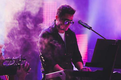 person man in black coat singing musician