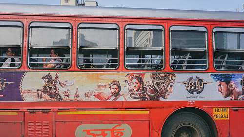 person red and white bus with graffiti bus