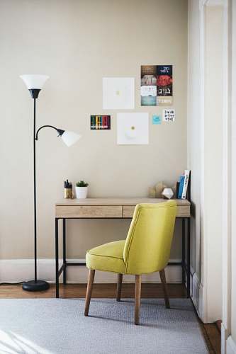 furniture black 2-light torchiere beside brown wooden-top desk with black steel frame chair