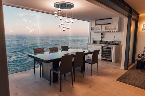 furniture dining table set placed beside glass window dining table