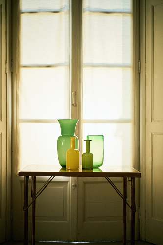 room photo of vases on top of table in front of window furniture