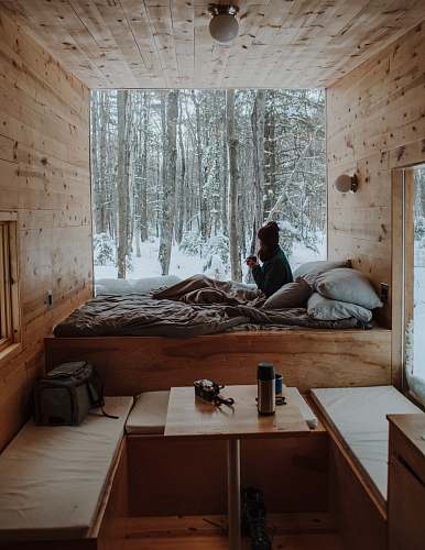 plywood woman sitting on bed watching by the window during winter furniture