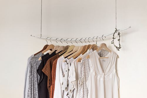 assorted clothes in wooden hangers