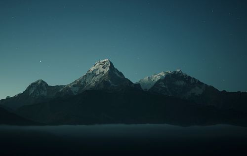 silhouette of mountains during nigh time photography