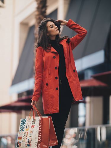 woman holding a paper bag walking on street