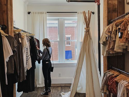 woman standing selecting clothes