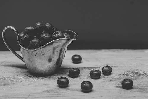 black-and-white pitcher filled with berries grey