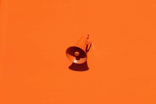 color orange megaphone on orange wall background