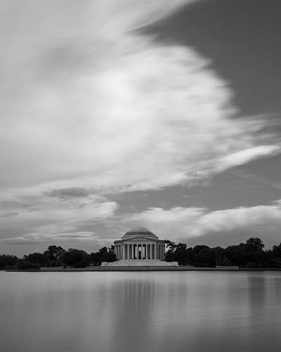architecture white building near trees and body of water black-and-white